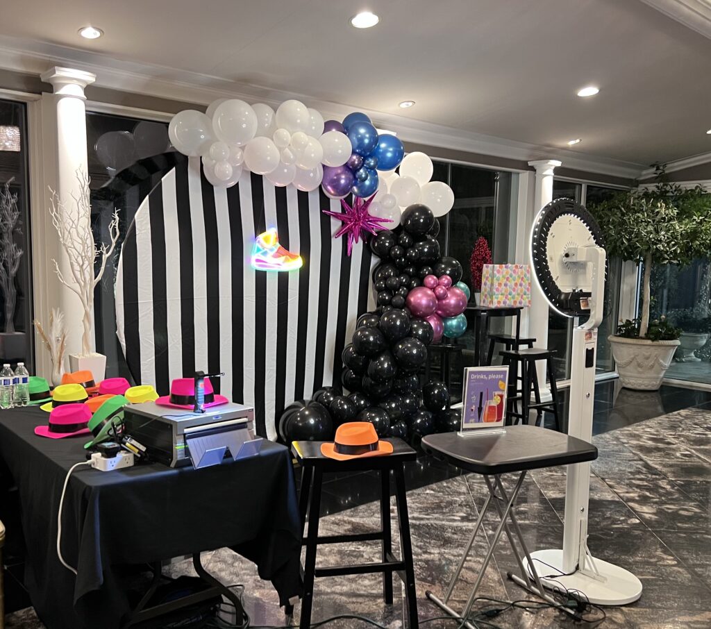 Photo Booth Setup with Striped Background showing printer and props